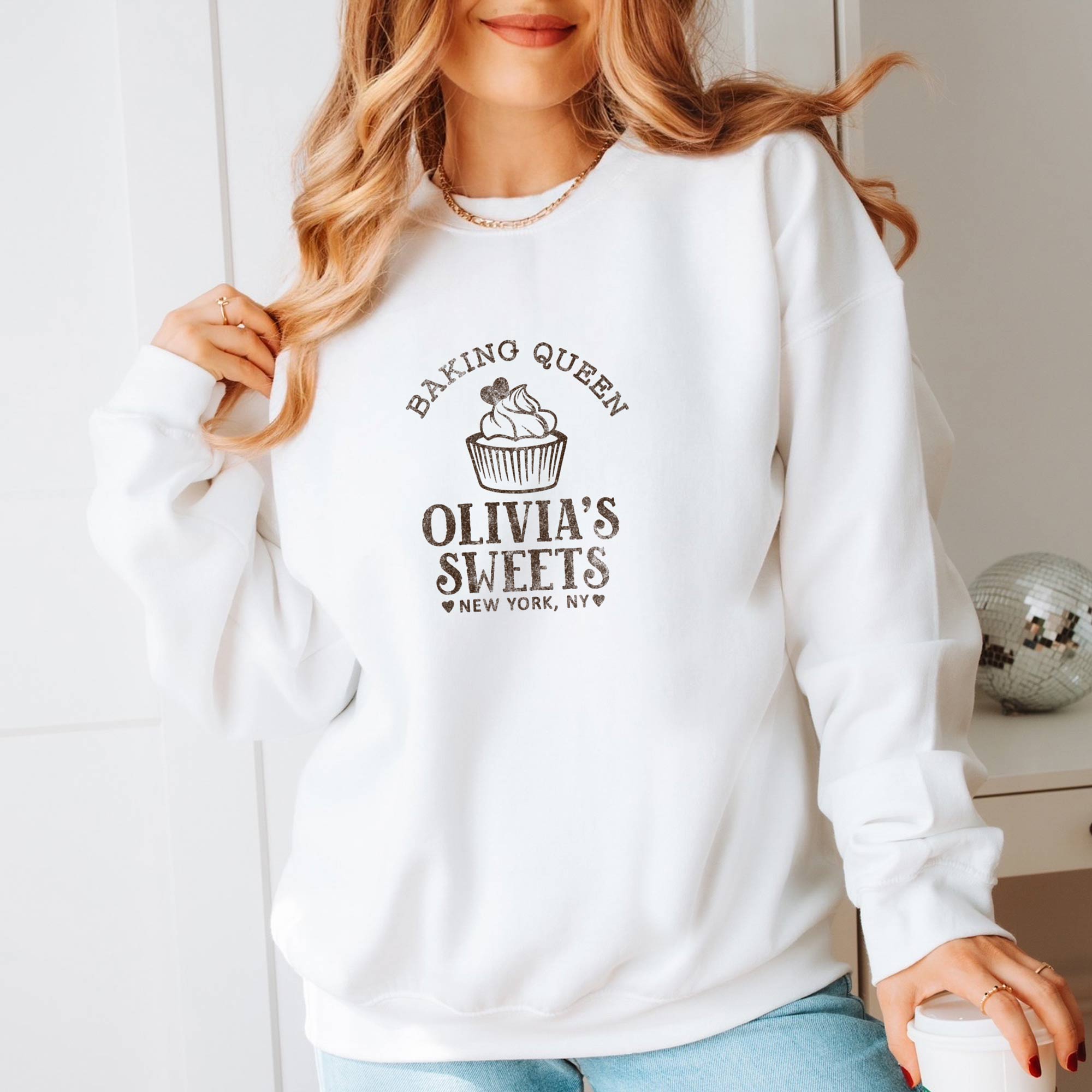a woman wearing a personalized Cupcake Baking Sweatshirt in white