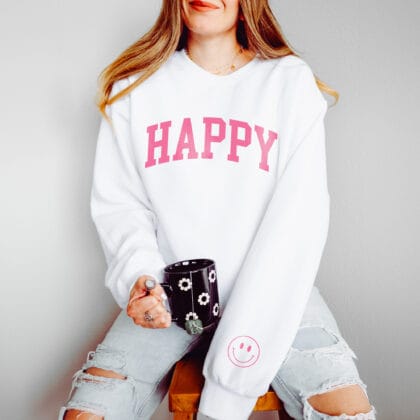 a young woman wearing an oversized Happy Smiley Sweatshirt in white
