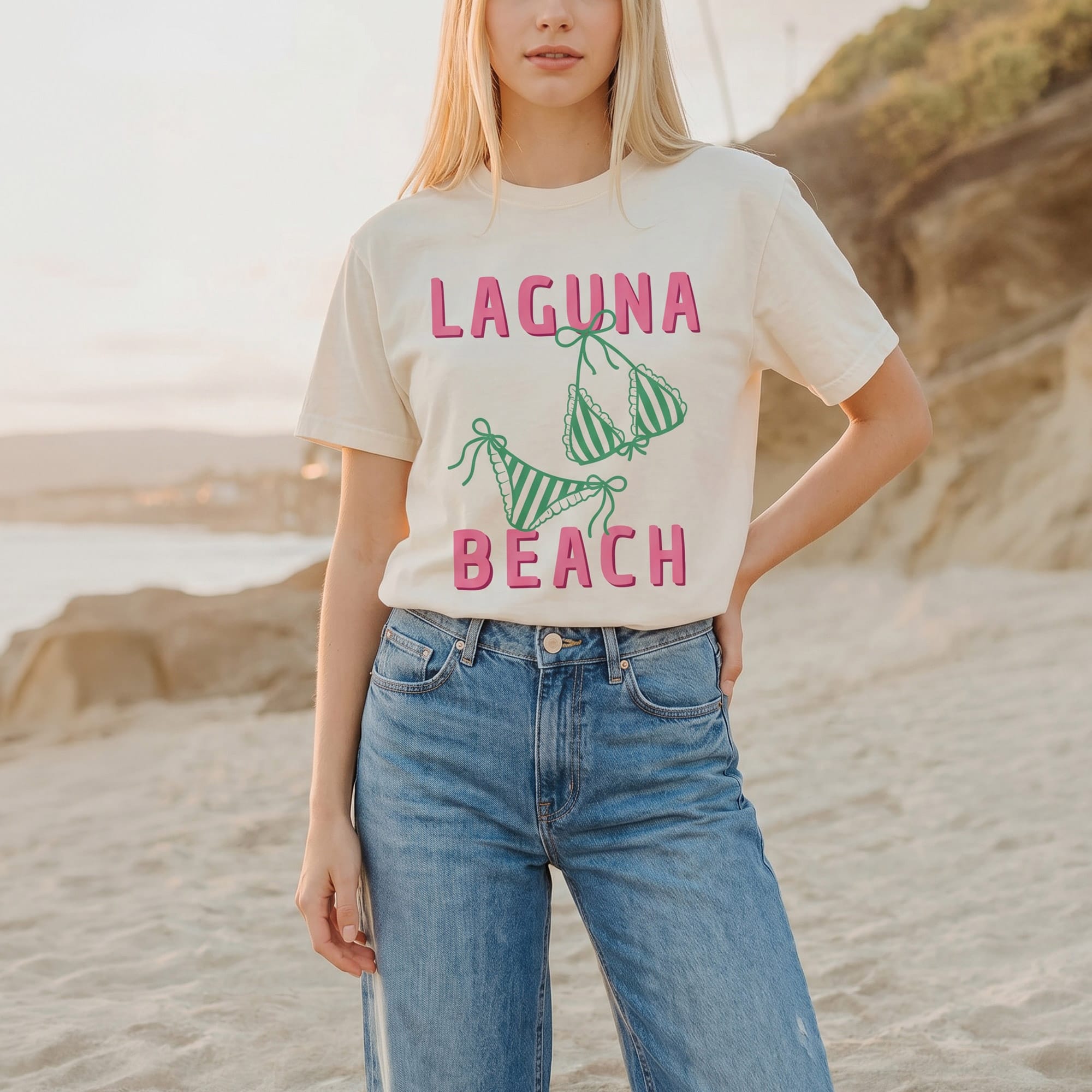 a young woman on the shore, wearing a pink and green Laguna Beach Shirt in ivory