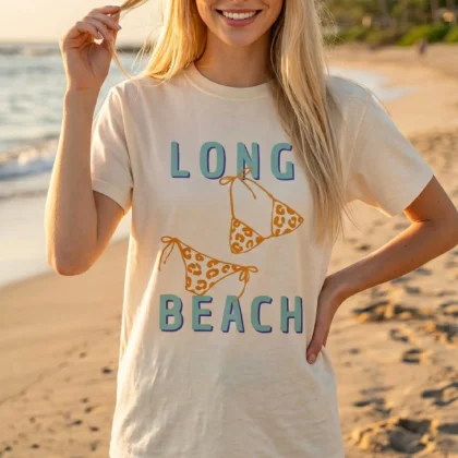 a woman on the shore, wearing a Long Beach Shirt in ivory