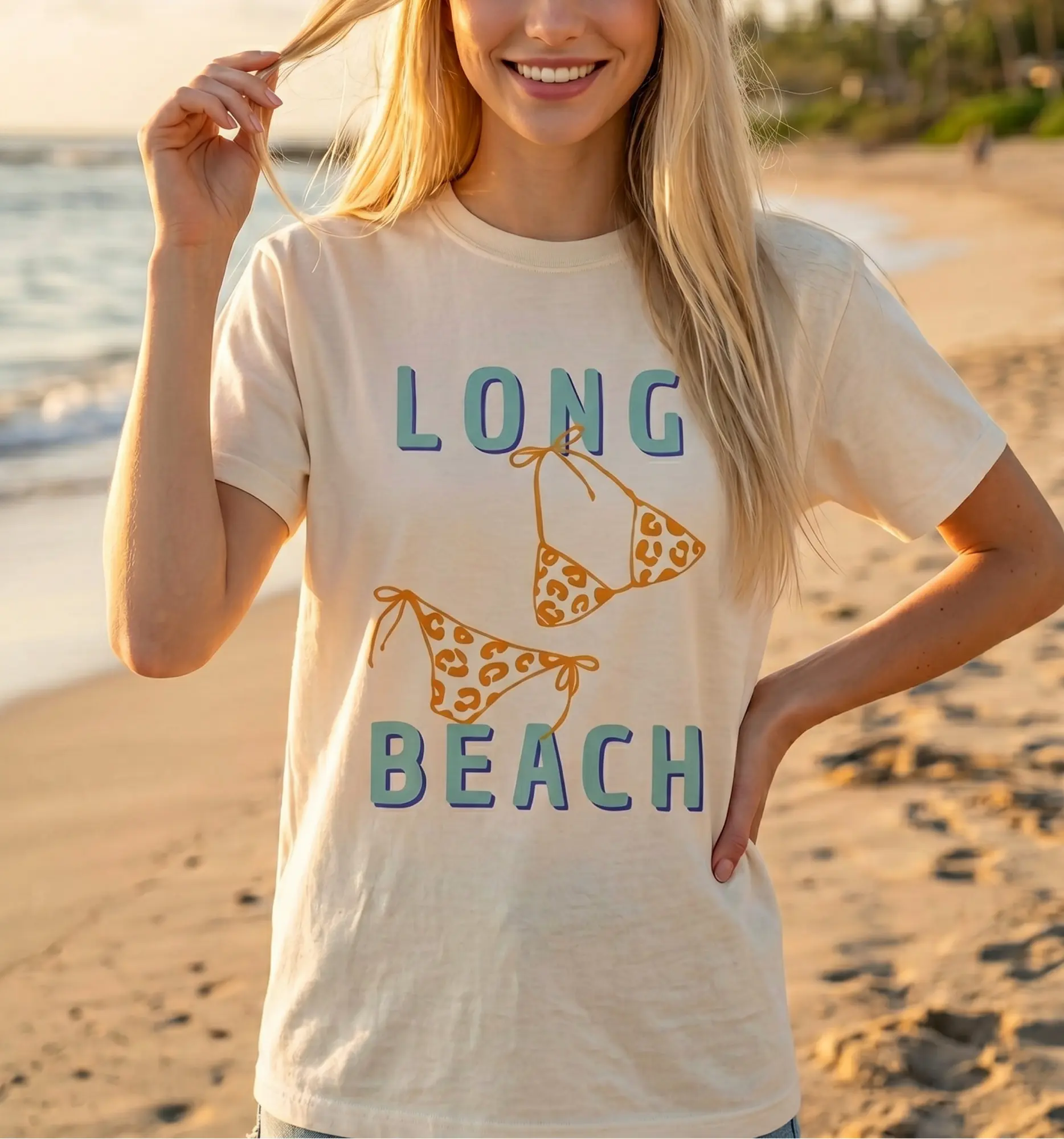 a woman on the shore, wearing a Long Beach Shirt in ivory