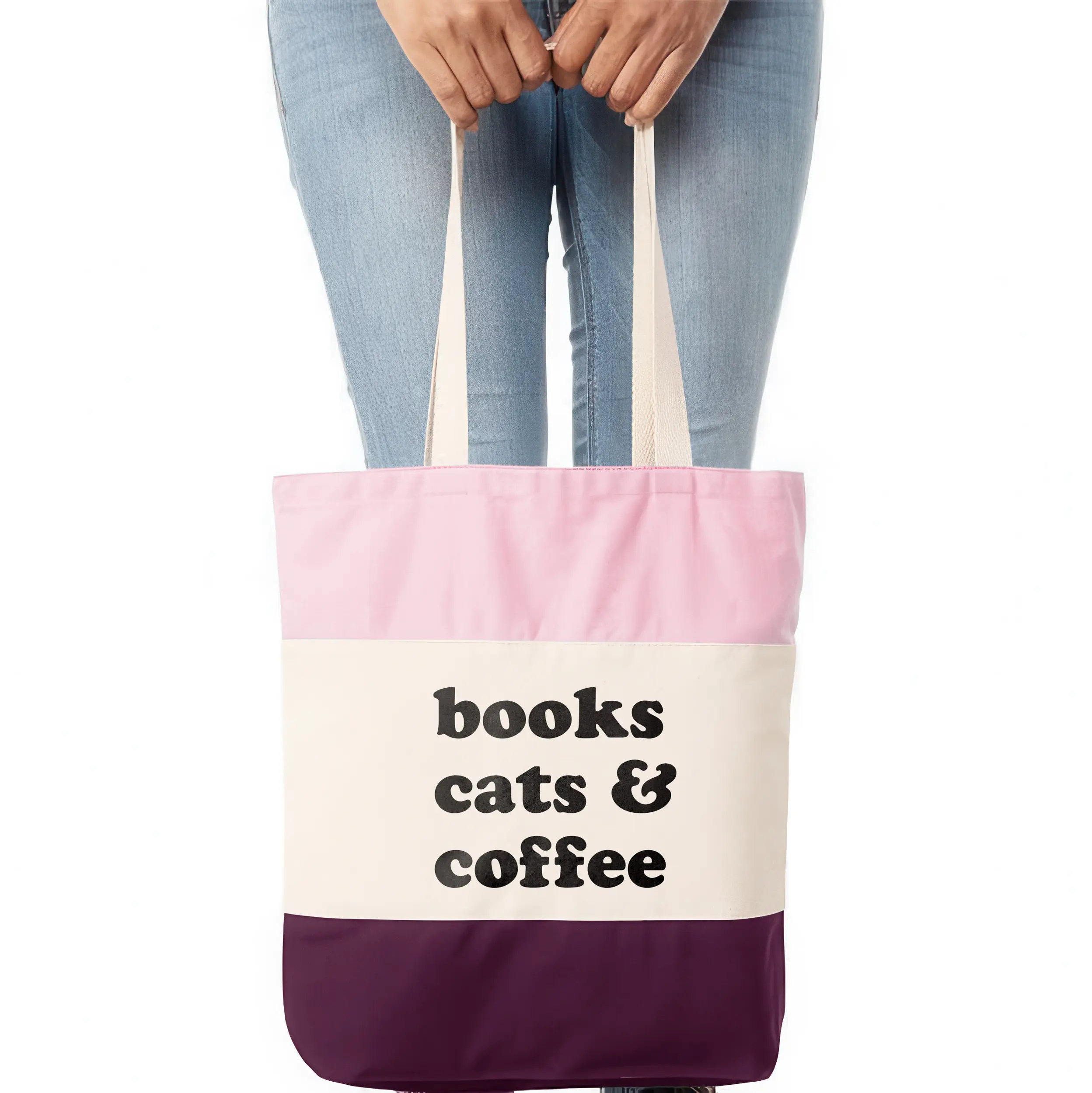 a woman holding A books cats coffee tote in pink
