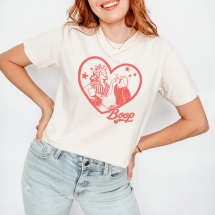 a happy woman wearing a boop eagle shirt in ivory