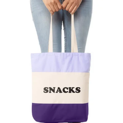 a woman holding a snacks tote bag in purple