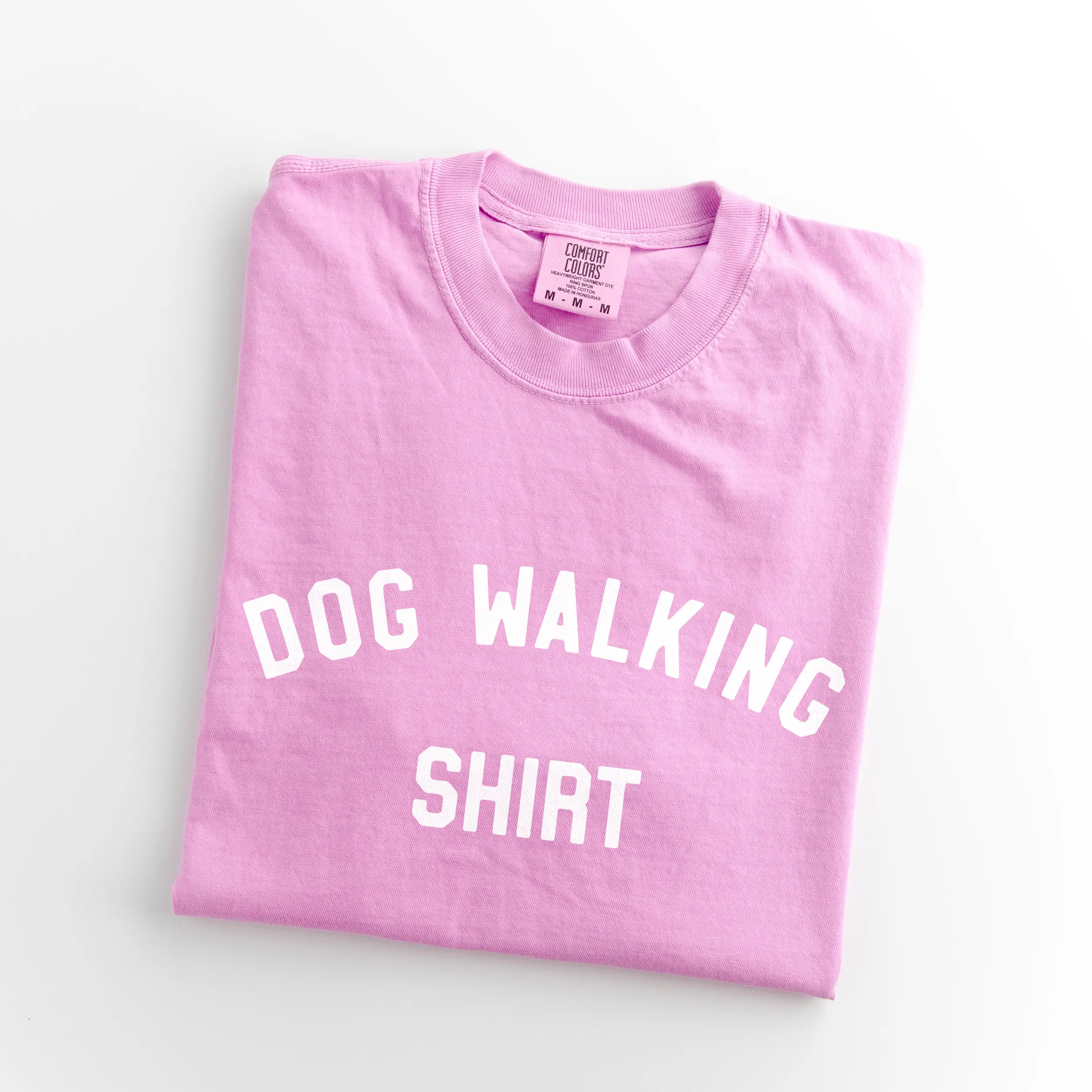 a dog walking shirt in rose quartz