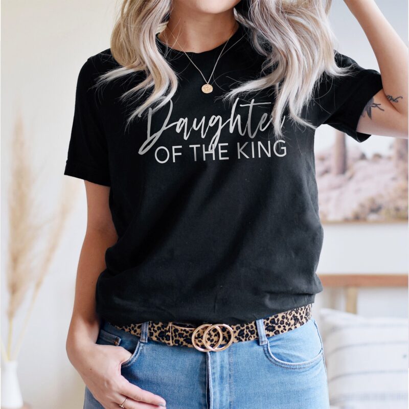 a young woman wearing a Daughter of the king t-shirt in black