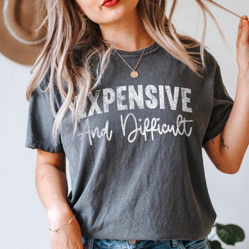 a pretty woman playing with her hair, wearing an Expensive And Difficult T-Shirt in pepper